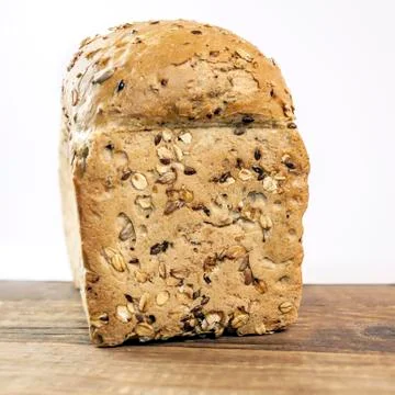 Dietary front grain bread isolated on wooden table on white background Stock Photos