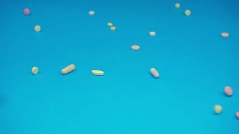Dietary supplements pills falling on blue background slow motion video tablets Video stock 155297722