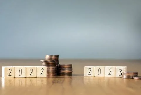 Difference coin stack savings in year 2022 and 2023. Economy recession crisis Stock Photos