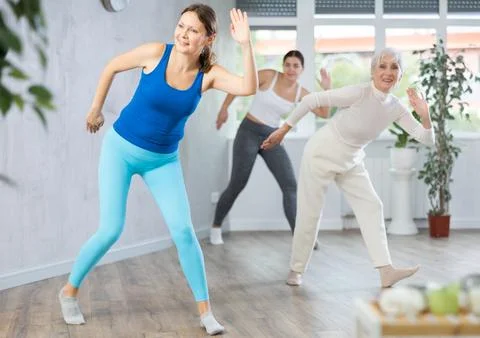 Different ages women learning swing steps at dance class Stock Photos