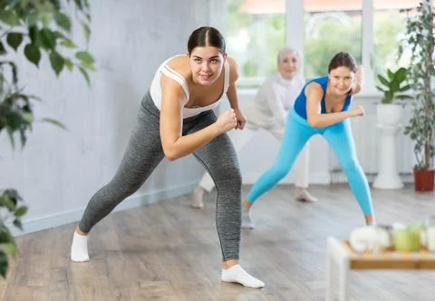 Different ages women learning swing steps at dance class Stock Photos