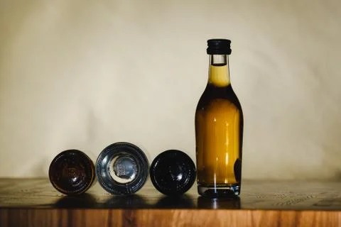Different alcohol bottles are on the table on a light background 库存照片