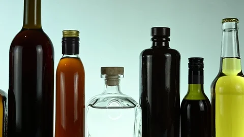 Different alcohol stands in a row on a white background Stock Footage 125502994