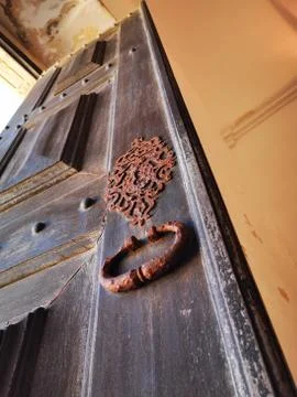 Different angle of old door with rusted decoration and handle Photos