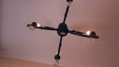 Different angles of a vintage crystal chandelier on ceiling lighting a room Stock Footage 79613797