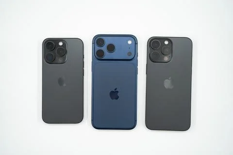 Different Apple iPhone models displayed side by side on white background. Stock Photos