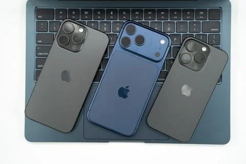 Different Apple iPhone models on MacBook laptop keyboard. Toronto, Canada - June Stock Photos