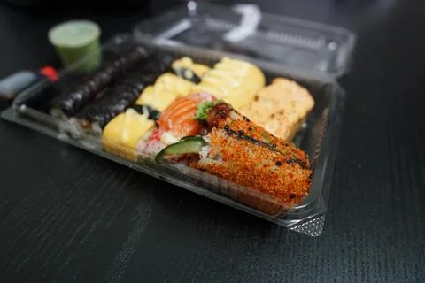 A different assortment of sushi rolls in plastic containers Stock Photos
