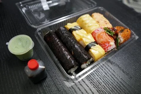 A different assortment of sushi rolls in plastic containers Stock Photos