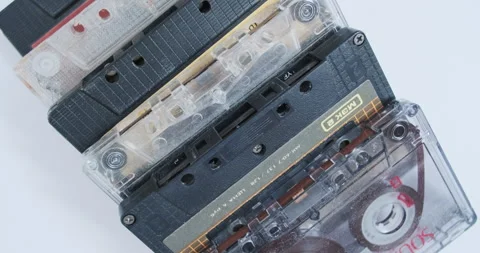 Different audio cassettes rotate on the table, top view. Retro magnetic type Vidéo 280183743