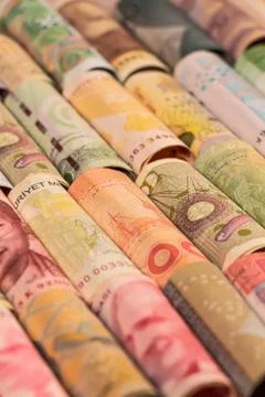 Different banknotes from various countries on rolls Stock Photos