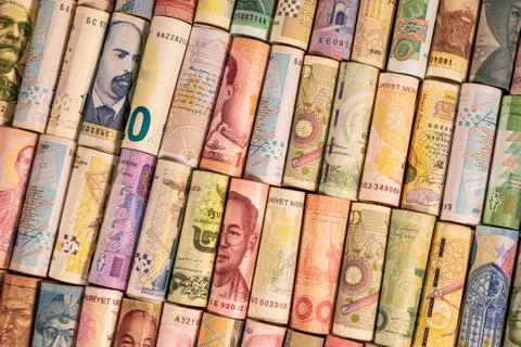 Different banknotes from various countries on rolls Stock Photos