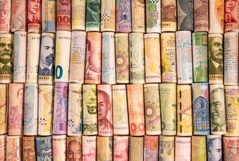 Different banknotes from various countries on rolls Stock Photos