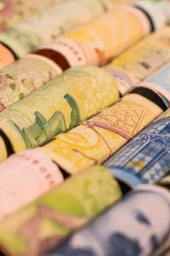 Different banknotes from various countries on rolls Foto stock