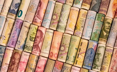 Different banknotes from various countries on rolls Stock Photos