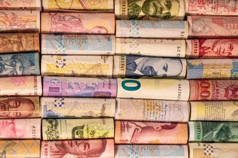Different banknotes from various countries on rolls Stock Photos