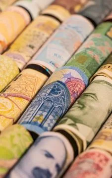Different banknotes from various countries on rolls Stock Photos
