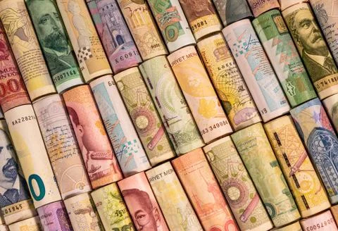 Different banknotes from various countries on rolls Stock Photos