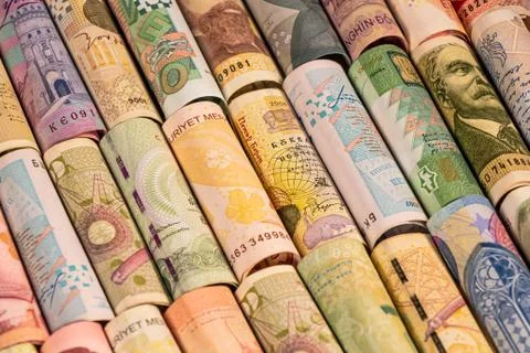 Different banknotes from various countries on rolls Stock Photos