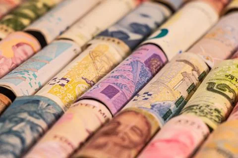 Different banknotes from various countries on rolls Stock Photos