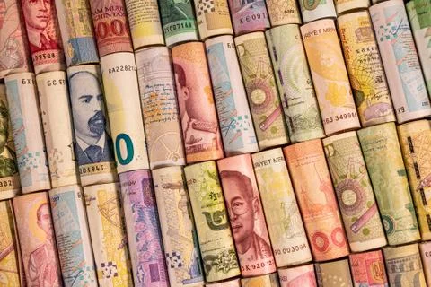 Different banknotes from various countries on rolls Stock Photos
