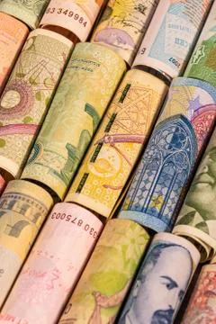 Different banknotes from various countries on rolls Stock Photos