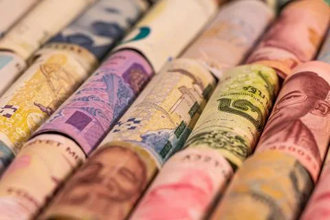 Different banknotes from various countries on rolls Stock Photos