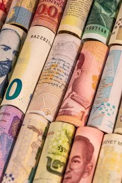 Different banknotes from various countries on rolls Stock Photos