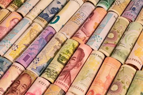 Different banknotes from various countries on rolls Stock Photos