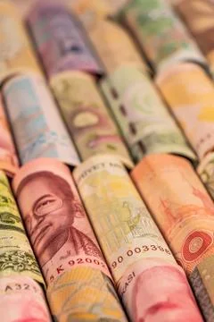 Different banknotes from various countries on rolls Stock Photos