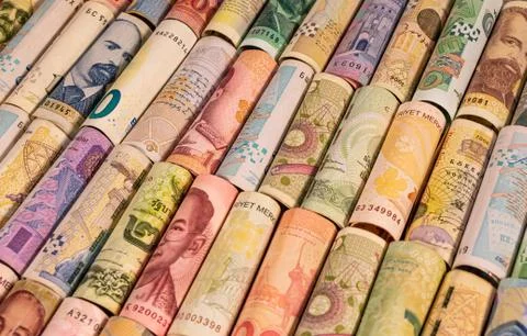Different banknotes from various countries on rolls Stock Photos