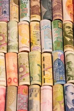 Different banknotes from various countries on rolls Stock Photos