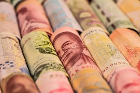 Different banknotes from various countries on rolls Stock Photos