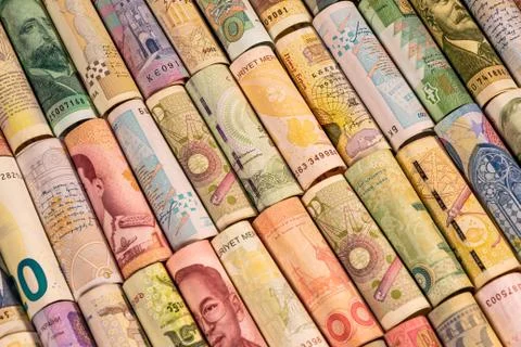 Different banknotes from various countries on rolls Stock Photos