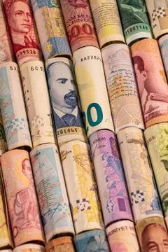 Different banknotes from various countries on rolls Stock Photos