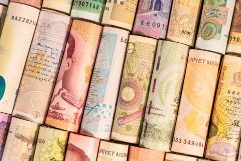 Different banknotes from various countries on rolls Stock Photos