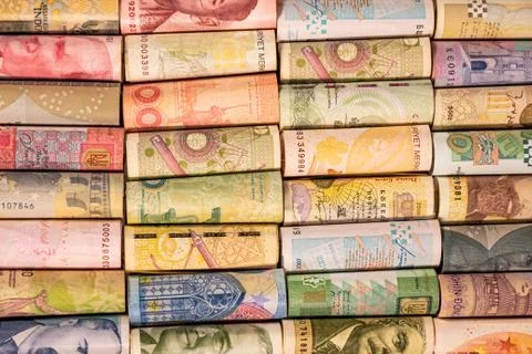 Different banknotes from various countries on rolls Stock Photos