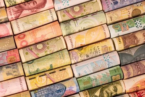 Different banknotes from various countries on rolls Stock Photos
