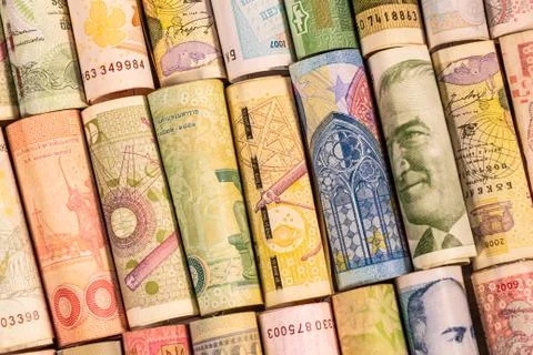 Different banknotes from various countries on rolls Stock Photos