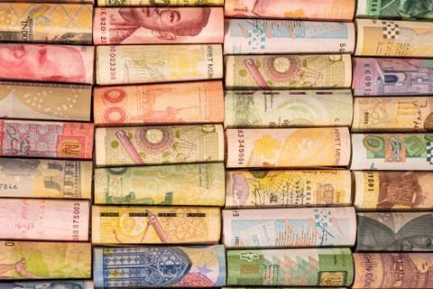 Different banknotes from various countries on rolls Stock Photos