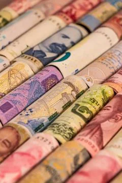 Different banknotes from various countries on rolls Stock Photos