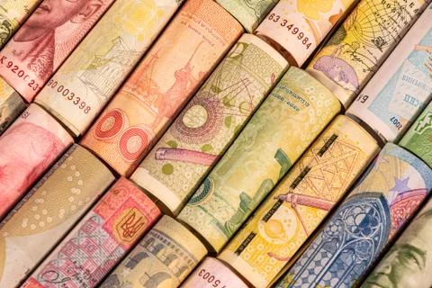 Different banknotes from various countries on rolls Stock Photos