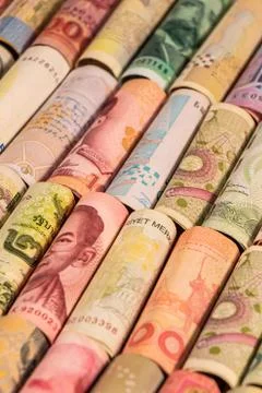 Different banknotes from various countries on rolls Foto stock