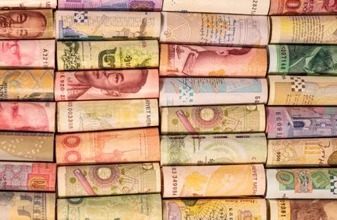 Different banknotes from various countries on rolls Stock Photos