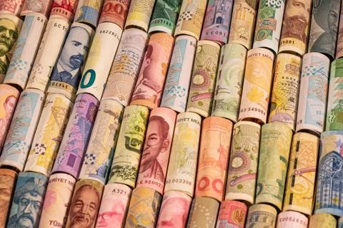 Different banknotes from various countries on rolls Stock Photos