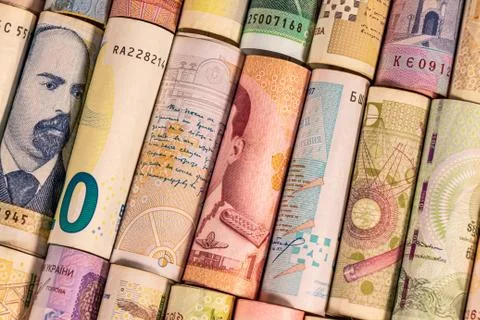 Different banknotes from various countries on rolls Stock Photos