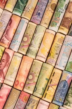 Different banknotes from various countries on rolls Stock Photos