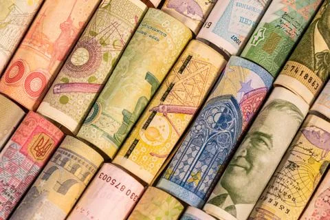 Different banknotes from various countries on rolls Stock Photos