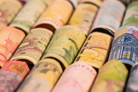 Different banknotes from various countries on rolls Stock Photos