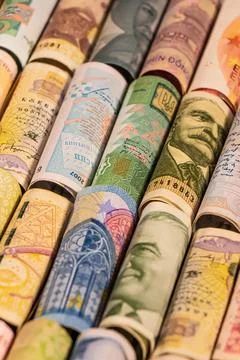 Different banknotes from various countries on rolls Stock Photos